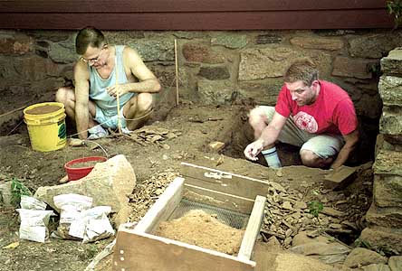 Tom Zoubek, right, director of the Stamford Historical Society, and volunteer Brook Calswell look for artifacts