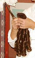 Hairpieces were commonly added to a woman's own tresses, curled with  heated curling irons, for formal evening wear.
