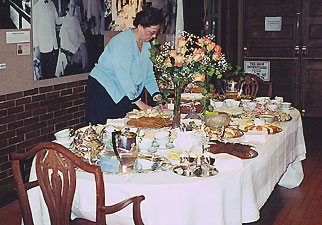 Pam Whitney is putting final touches to the tea table.