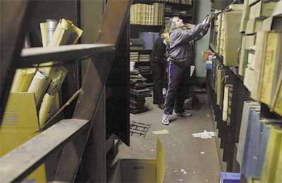 Maria Stabile, from the city and town clerk's office, sorts through documents Maria Stabile, from the city and town clerk's office, sorts through documents in the basement of Old Town Hall