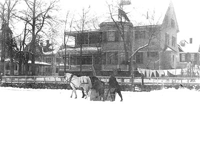 horse-drawn snow plane scraping snow from the ice