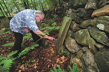 Richard Roberts inspects the headstone on Seth Smith's grave